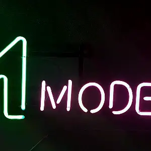 녹색 대문자 M과 핑크색 MODERNIC이 들어간 바버샵네온사인