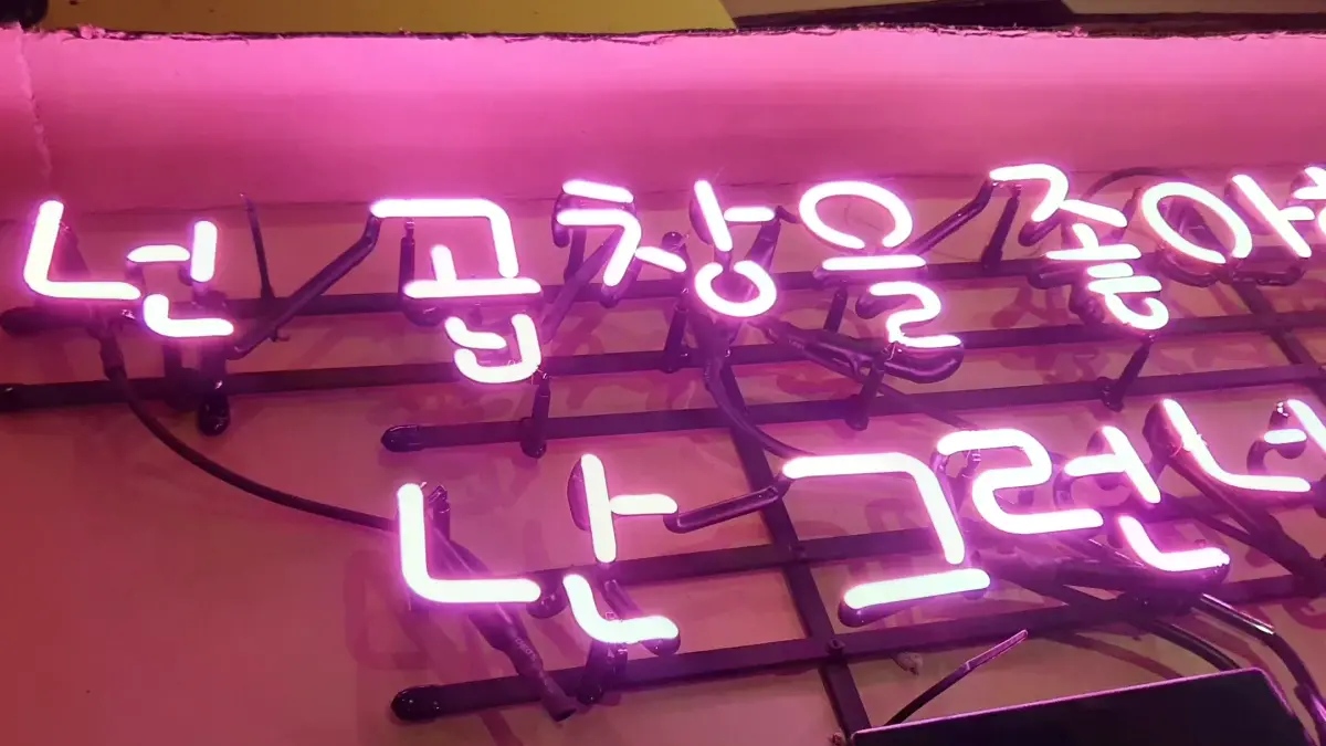 첫마디와 대답을 위아래로 나눈 핑크색 식당 네온사인 간판